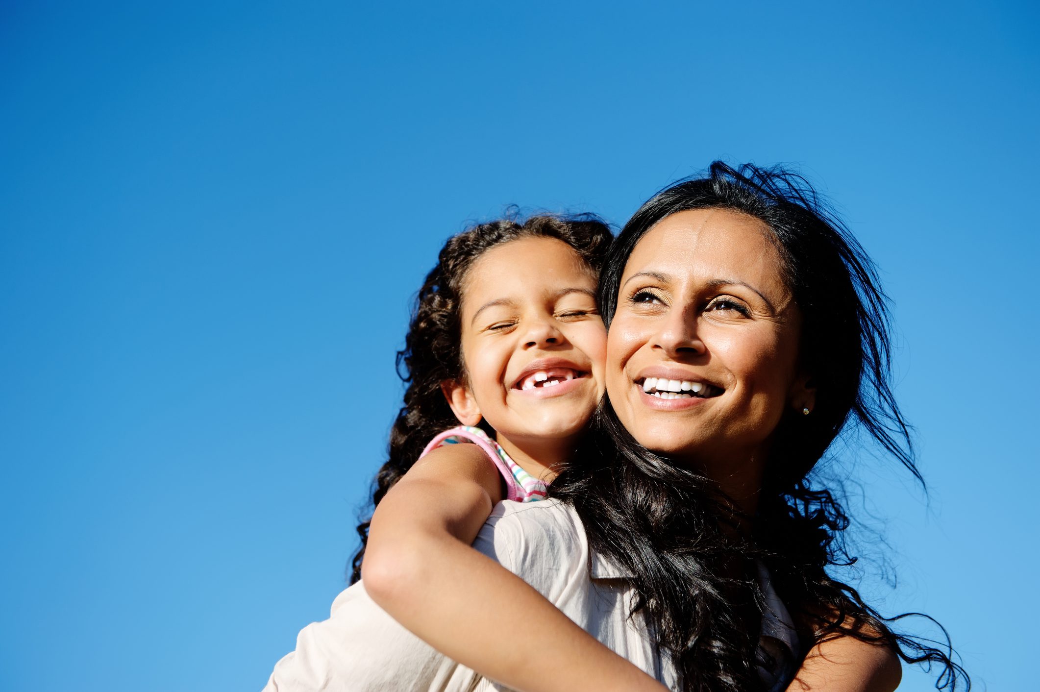 carefree vitality image of mother and daughter playing together outdoors