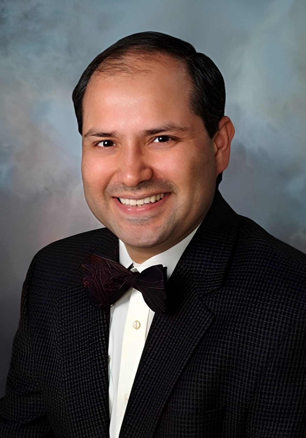 Man wearing bowtie and formal suit.